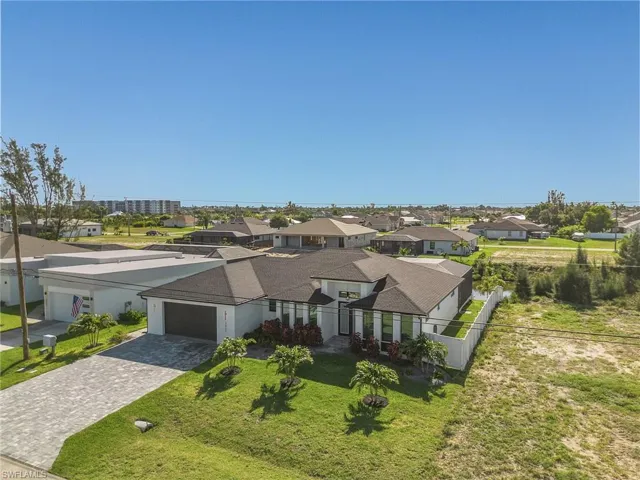 View of front of home featuring a garage and a front yard