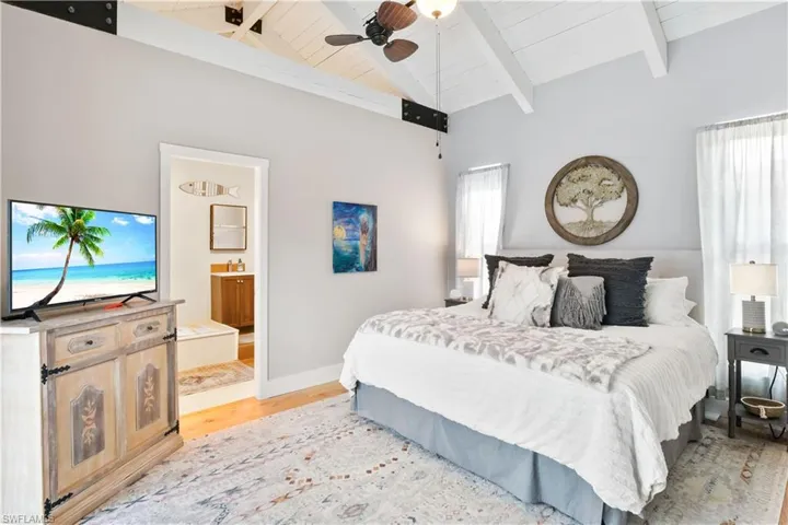 Junior master suite is still very spacious and features double doors to the outside pool, beautiful vaulted ceilings and features a double fan and more of those gorgeous hardwood hickory floors!