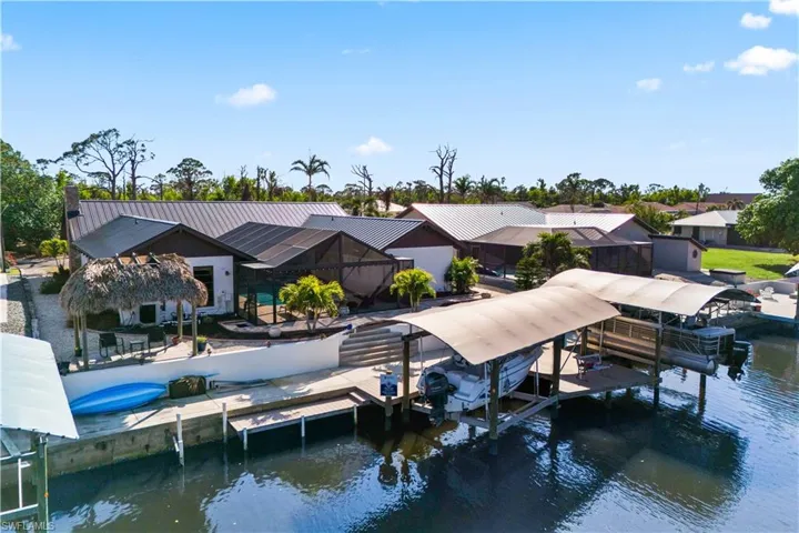 TWO ten thousand pound boat lifts, with extensive captain's walk and outdoor lounging area between the boat lifts. A tiki hit, additional launch deck and an extensive concrete patio are just a few additional details! Even the landscaping is perfect!