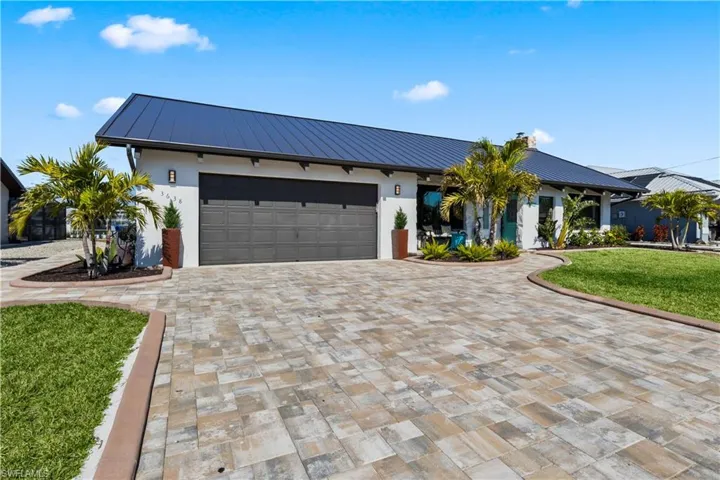 Walkway to the back for easy maneuvering groceries/wheelbarrow and supplies to the boats! Wide pavered driveway and walkway to the front door!