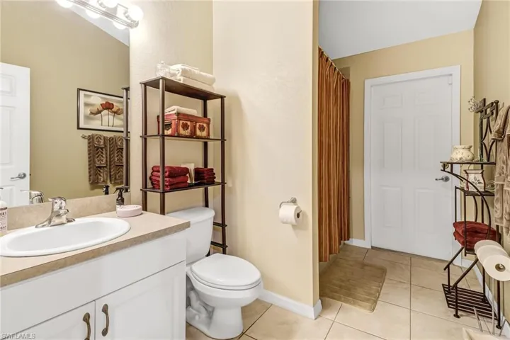 Bathroom featuring vanity, toilet, and tile patterned flooring
