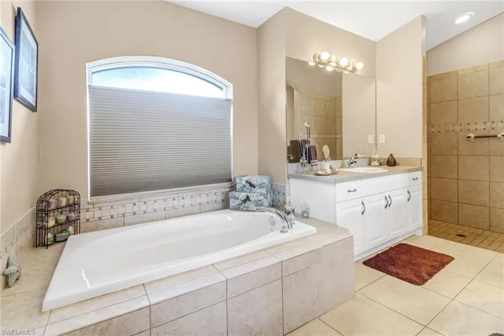 Bathroom with vanity, independent shower and bath, and tile patterned floors