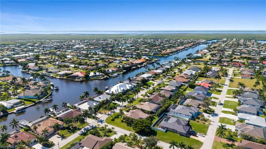 Aerial overview of property's location with a nearby body of water and nearby suburban area
