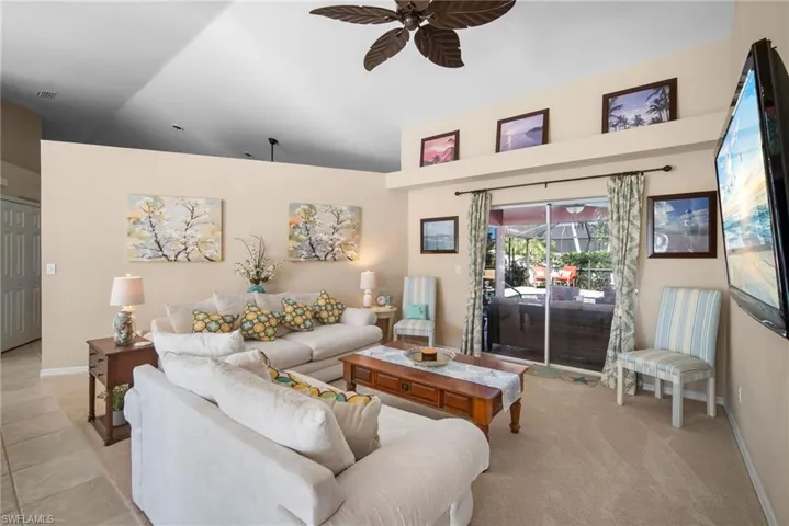 Living area featuring vaulted ceiling and a ceiling fan