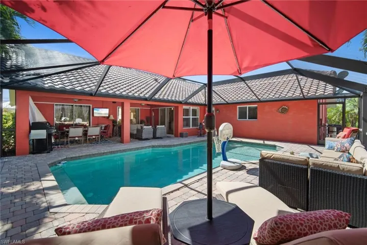 Outdoor pool featuring an outdoor living space, a lanai, a patio, and a grill