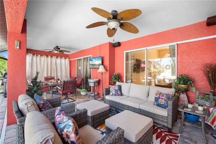 View of patio with outdoor lounge area, outdoor dining area, and a ceiling fan