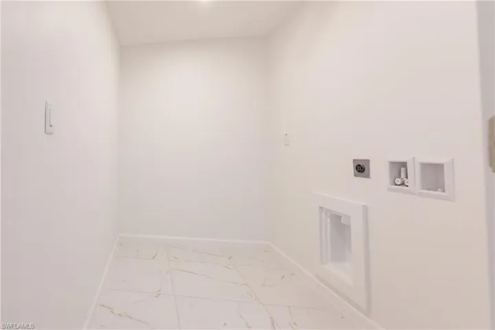 Laundry room featuring electric dryer hookup, marble finish floors, and hookup for a washing machine