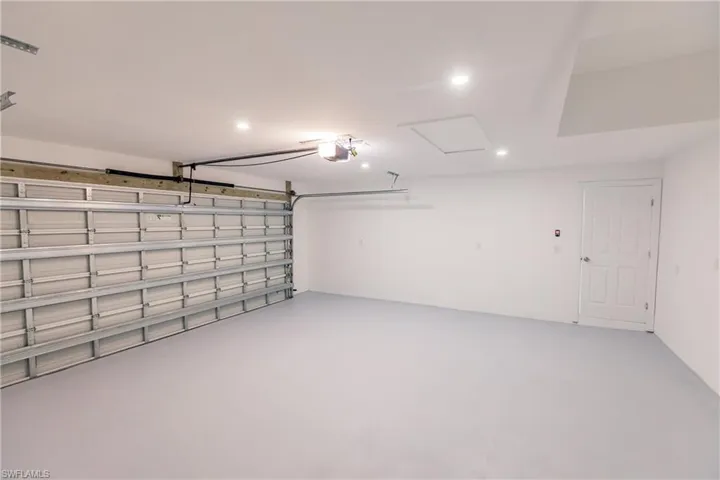 Garage with recessed lighting and a garage door opener