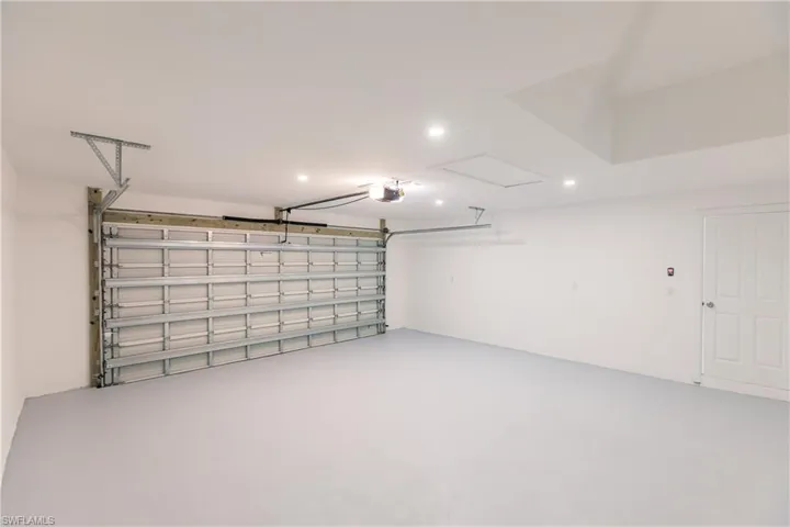 Garage featuring recessed lighting and a garage door opener