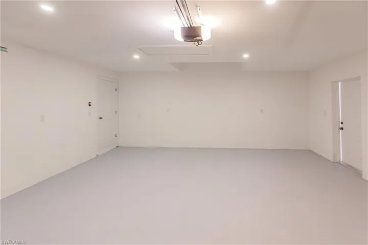Garage with recessed lighting and a garage door opener