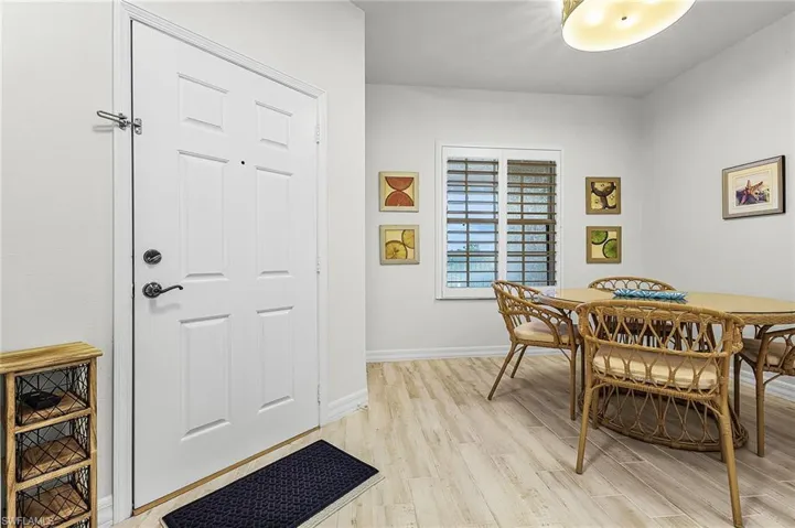 Dining room with light wood-type porcelain flooring.