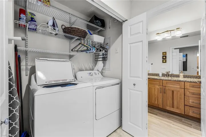 Washroom featuring wood tiled floors and separate washer and dryer
