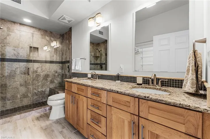 Primary Bathroom with double vanity and double shower stall