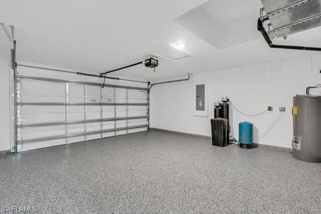 Spacious garage with epoxy flooring, white walls, and an overhead garage door opener system
