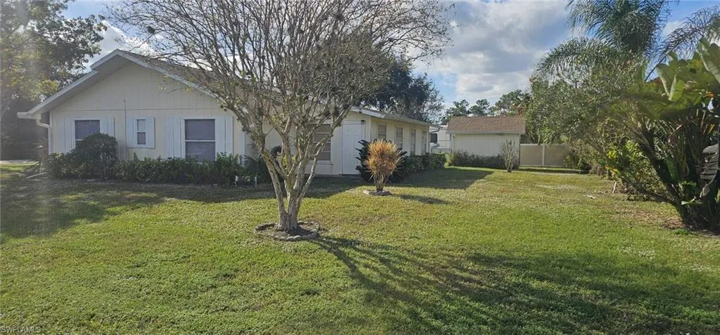 View of side of home featuring a yard
