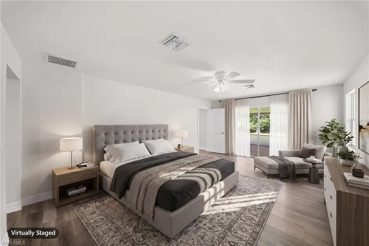 Wood-finish flooring, sliding glass doors, ceiling fan with integrated light fixture, and neutral wall tones