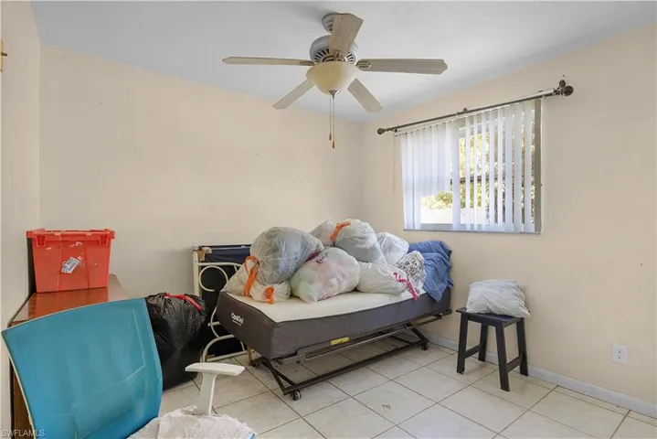 Bedroom featuring tile patterned floors and ceiling fan