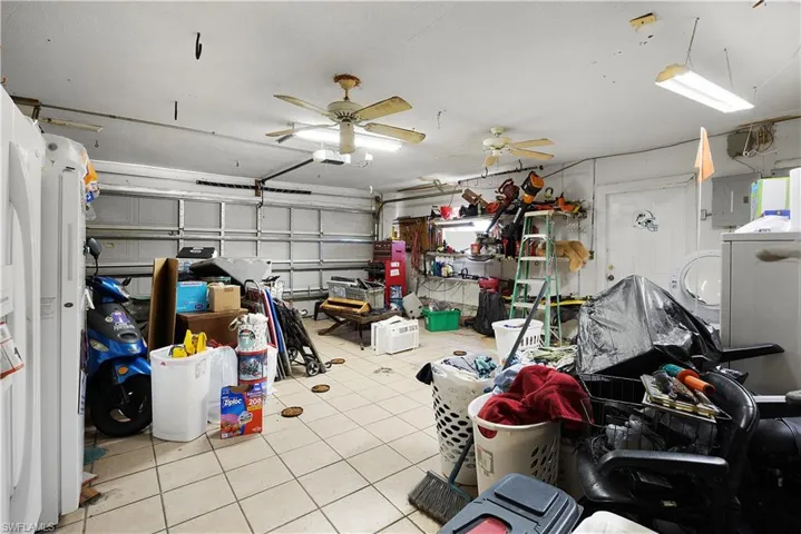 Garage with electric panel and ceiling fan