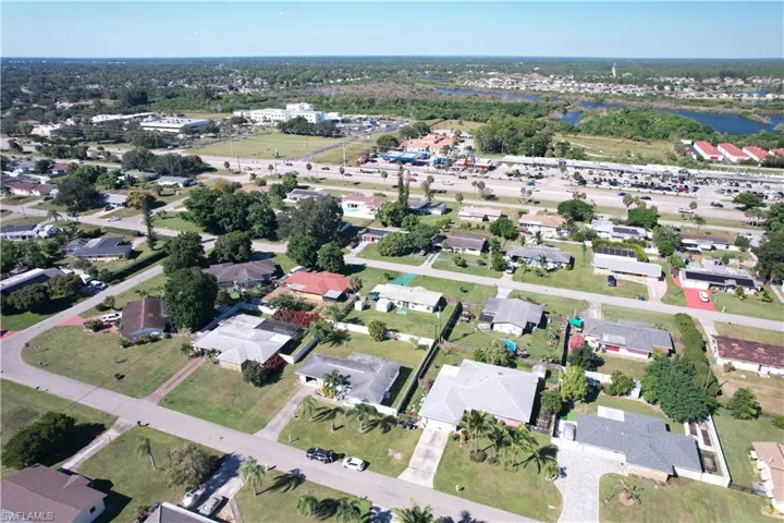 Aerial view of property's location with nearby suburban area