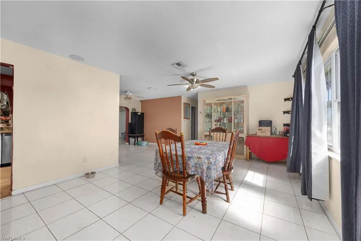 Dining area with light tile patterned flooring and ceiling fan