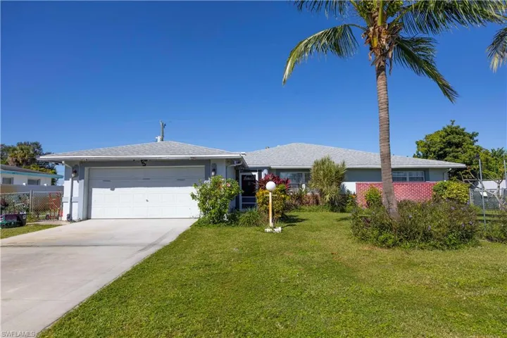 Ranch-style home with stucco siding, driveway, and an attached garage