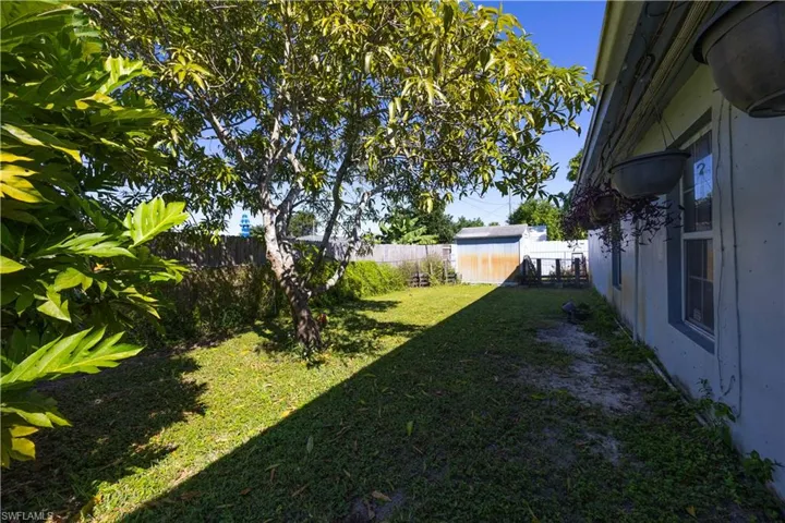 Fenced backyard featuring an outdoor structure