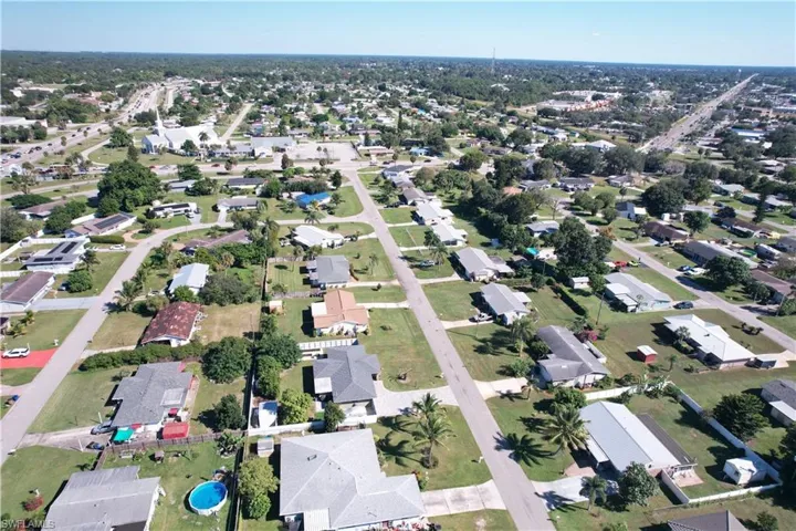 Aerial view of property's location with nearby suburban area