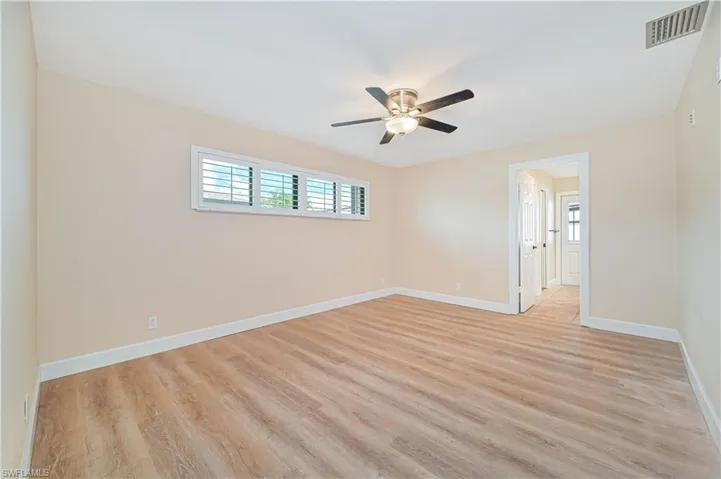 Spare room featuring light wood-style flooring and ceiling fan