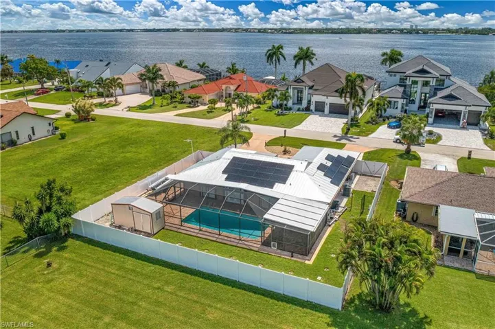 Aerial view of residential area featuring a nearby body of water