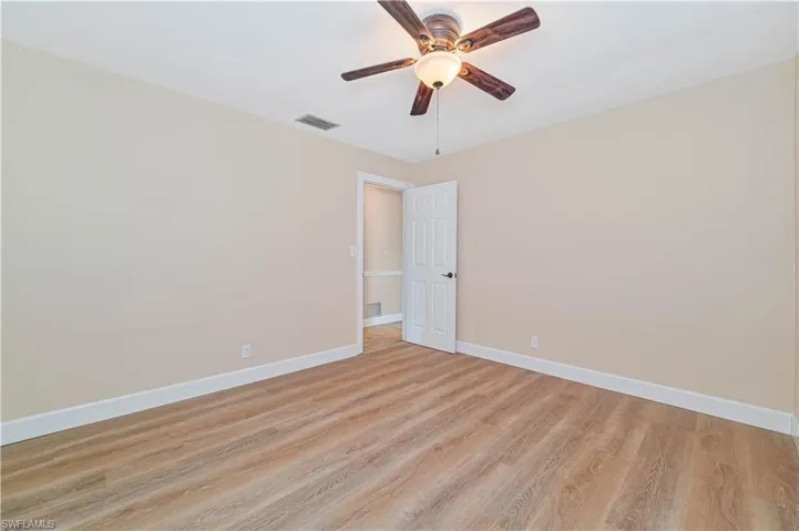 Empty room with light wood-type flooring and a ceiling fan