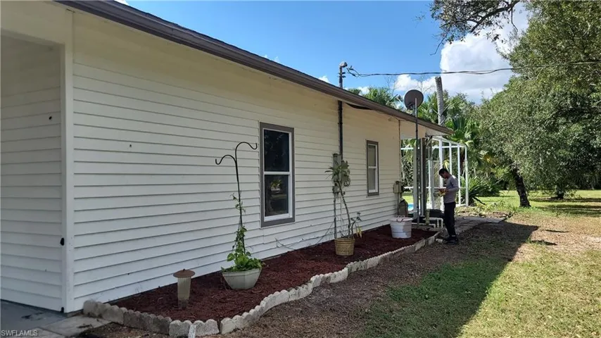 View of side of property with a yard