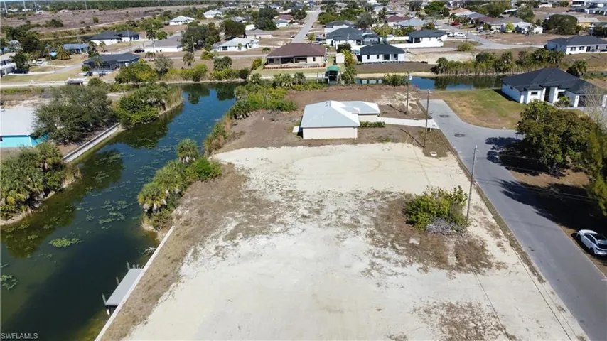 Aerial perspective of suburban area featuring a large body of water