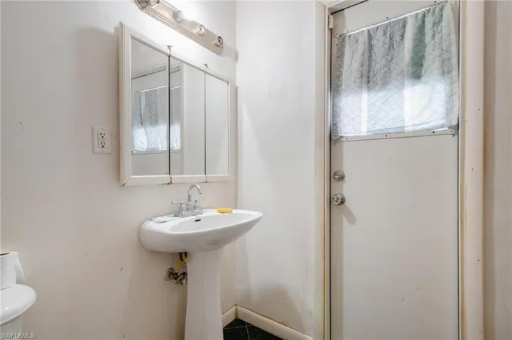 Bathroom featuring toilet, a healthy amount of sunlight, and tile patterned flooring