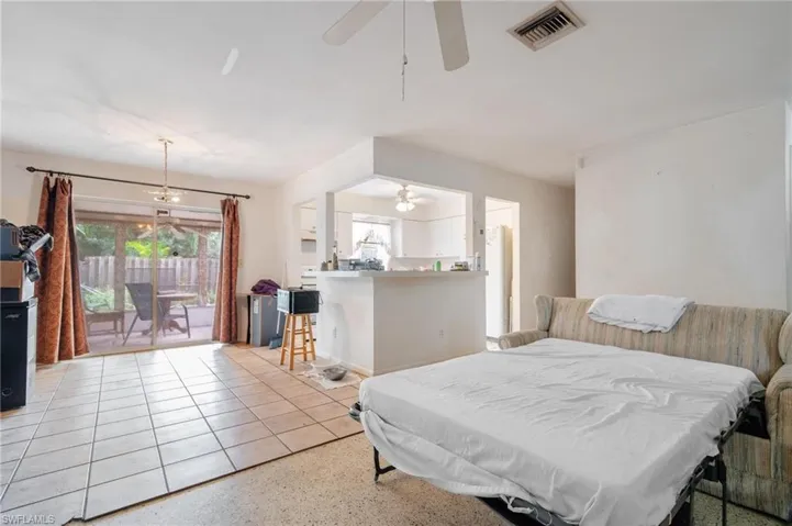 Bedroom featuring access to exterior, ceiling fan, and multiple windows