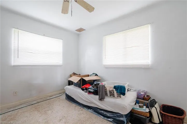 Kitchen featuring white cabinets, a chandelier, sink, white electric stove, and decorative backsplash