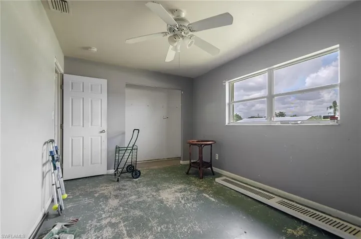 Bedroom featuring a baseboard heating unit and ceiling fan