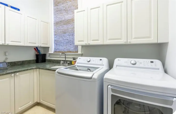 Laundry area with washer and clothes dryer and cabinet space