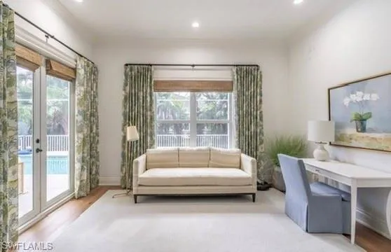 Office space with wood finished floors, crown molding, and recessed lighting