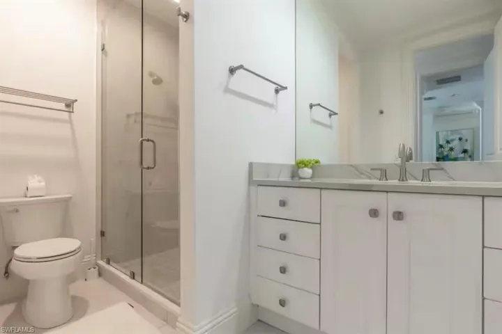 Full bathroom with vanity and a stall shower