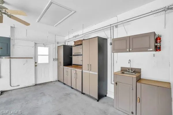 Kitchen with sink, ceiling fan, and electric panel