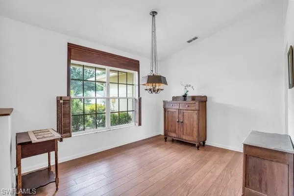 Dining space featuring a notable chandelier and hardwood / wood-style floors