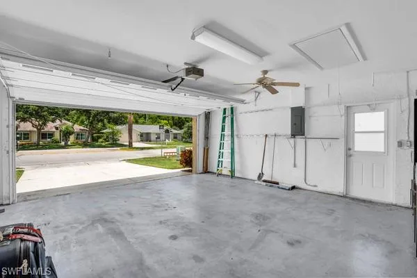 Garage with electric panel and ceiling fan