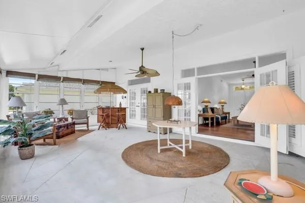 Sunroom featuring ceiling fan and vaulted ceiling