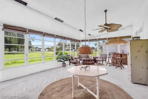 Sunroom with ceiling fan and vaulted ceiling