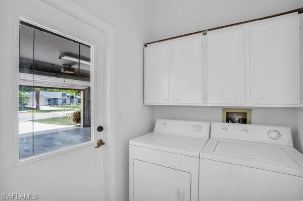 Laundry room with cabinets and washing machine and dryer