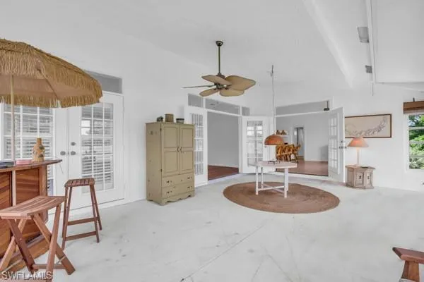Living room featuring ceiling fan and french doors
