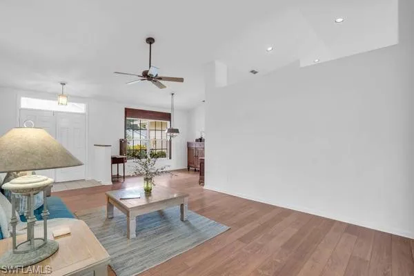 Living room featuring ceiling fan and wood-type flooring