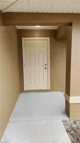 Entrance to property with stucco siding