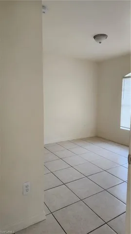 Unfurnished room featuring baseboards and light tile patterned floors