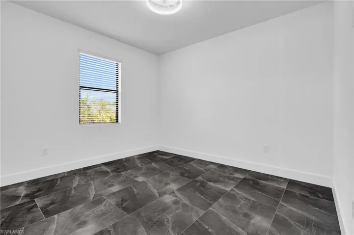 Unfurnished room with baseboards